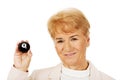 Happy elderly business woman holding eight billard-ball Royalty Free Stock Photo