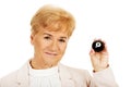 Happy elderly business woman holding eight billard-ball