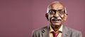 Happy elderly businessman on plain background