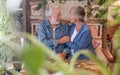 Happy elderly couple embracing looking into each other eyes having fun together at coffee shop. Two senior grandparents enjoying Royalty Free Stock Photo