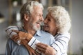 Happy elderly couple hug and cuddle sharing romantic moment Royalty Free Stock Photo