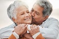 Happy elderly couple, hug and sunset with kiss on cheek, bonding and smile for romance, love and vacation. Senior man Royalty Free Stock Photo