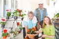 Happy elderly couple planting flower