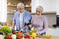 Happy Elderly Couple Preparing Tasty Lunch Together In Kitchen Royalty Free Stock Photo