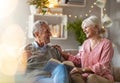 Happy elderly couple relaxing together on the sofa at home Royalty Free Stock Photo