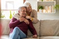 Happy elderly couple relaxing together on the sofa at home Royalty Free Stock Photo