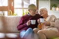 Happy elderly couple relaxing together on the sofa at home