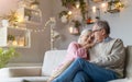 Happy elderly couple relaxing together on the sofa at home Royalty Free Stock Photo