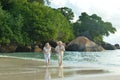 Happy elderly couple running on tropical beach Royalty Free Stock Photo