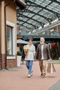 happy elderly couple, shopping, bouquet of Royalty Free Stock Photo