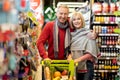 Happy elderly couple shopping together at supermarket Royalty Free Stock Photo