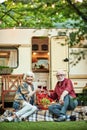 Happy elderly couple sitting on the porch of their camper van Royalty Free Stock Photo