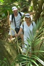 Happy elderly couple in tropical forest Royalty Free Stock Photo
