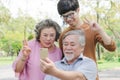 Happy elderly with family. Grandpa and grandma using mobile phone taking photo with grandson Royalty Free Stock Photo