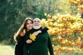 Happy elderly father and daughter enjoying autumn moment, smiling, hugging, cuddling. Grown up granddaughter with Royalty Free Stock Photo