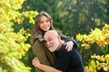 Happy elderly father and daughter enjoying tender autumn moment, smiling. Grown up daughter hugging mature man from back Royalty Free Stock Photo