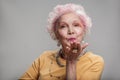 Happy elderly female posing with bright make-up