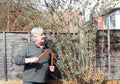 Happy gardener pruning a bush.