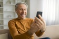 Happy elderly man have video chat with family, using phone Royalty Free Stock Photo