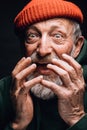 A happy elderly man looking extremely surprised and astonished, close up face. Royalty Free Stock Photo