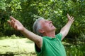 Happy elderly man in a park Royalty Free Stock Photo