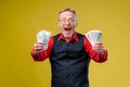 Happy elderly man showing two bunches of money. Focus on money and hands. Positive emotion facial expression feelings. Royalty Free Stock Photo