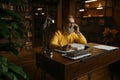 Happy elderly man talking phone while working at home office in evening Royalty Free Stock Photo