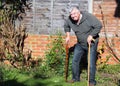 Happy elderly man with two walking sticks.