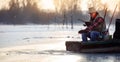 Happy man on winter fishing on the frozen lake Royalty Free Stock Photo