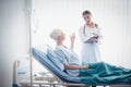 Happy Elderly patient talk with woman doctor at room in hospital. Healthcare homecare concept