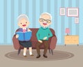 Happy elderly reading book together on sofa Royalty Free Stock Photo