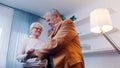 Happy elderly retired couple dancing at home. Birthday, valentines day or anniversary concept Royalty Free Stock Photo