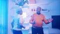 Happy elderly retired couple dancing at home. Birthday, valentines day or anniversary concept Royalty Free Stock Photo