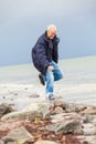 Happy elderly senior couple walking on beach