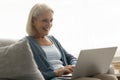 Happy elderly senior freelance woman typing laptop computer Royalty Free Stock Photo