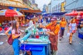 The happy elderly vendor preparing homemade ice cream with toppings, Chinatown of Bangkok, Thailand