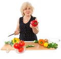 Happy elderly woman cooking food Royalty Free Stock Photo