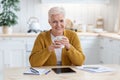 Happy elderly woman having coffee break while studying online Royalty Free Stock Photo