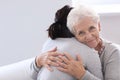 Happy elderly woman with her daughter at home Royalty Free Stock Photo