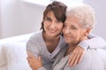 Happy elderly woman with her daughter at home