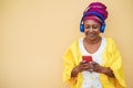 Happy elderly woman listening to playlist music on mobile phone app - Focus on face