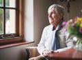 Happy elderly woman looking out window thinking of memories pensioner retirement lifestyle concept Royalty Free Stock Photo