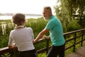 Happy elderly woman and man friends having nice conversation resting after run Royalty Free Stock Photo