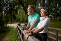 Happy elderly woman and man friends having nice conversation resting after run Royalty Free Stock Photo