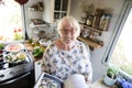 Happy elderly woman reading a cookbook Royalty Free Stock Photo