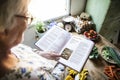 Happy elderly woman reading a cookbook Royalty Free Stock Photo