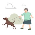 Happy elderly woman walking with a dog at summer park. Joyful owner and domestic animal enjoying promenade outdoor.
