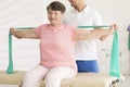 Elderly woman stretching during physiotherapy