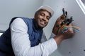 happy electrician installing socket in new house Royalty Free Stock Photo