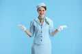 happy elegant air hostess woman on blue gesturing Royalty Free Stock Photo